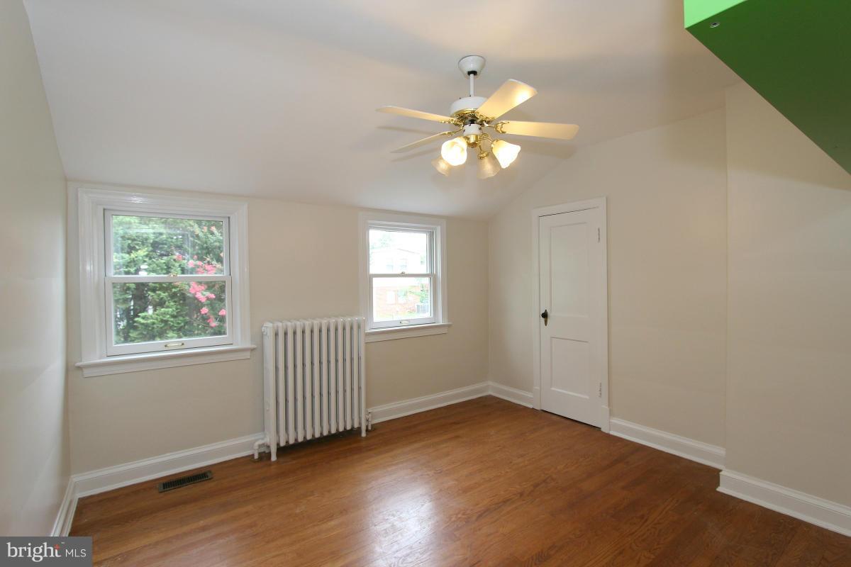 10022 Dallas Avenue Silver Spring, MD 20901 - Photo 20 of 30 a view of an empty room with a window and wooden floor