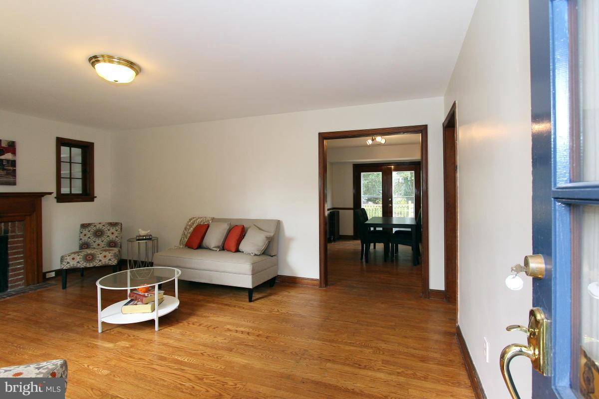 10022 Dallas Avenue Silver Spring, MD 20901 - Photo 3 of 30 a living room with furniture and a wooden floor