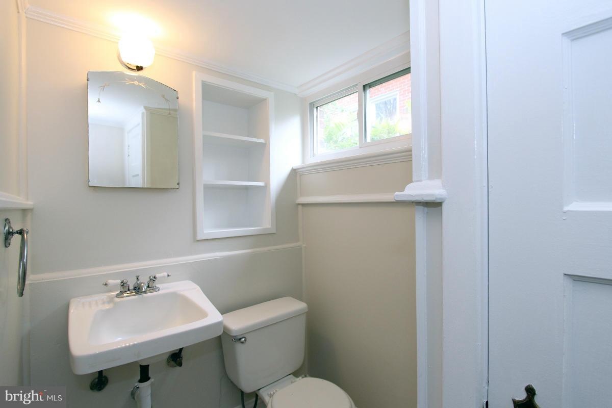 10022 Dallas Avenue Silver Spring, MD 20901 - Photo 24 of 30 a bathroom with a toilet sink and mirror