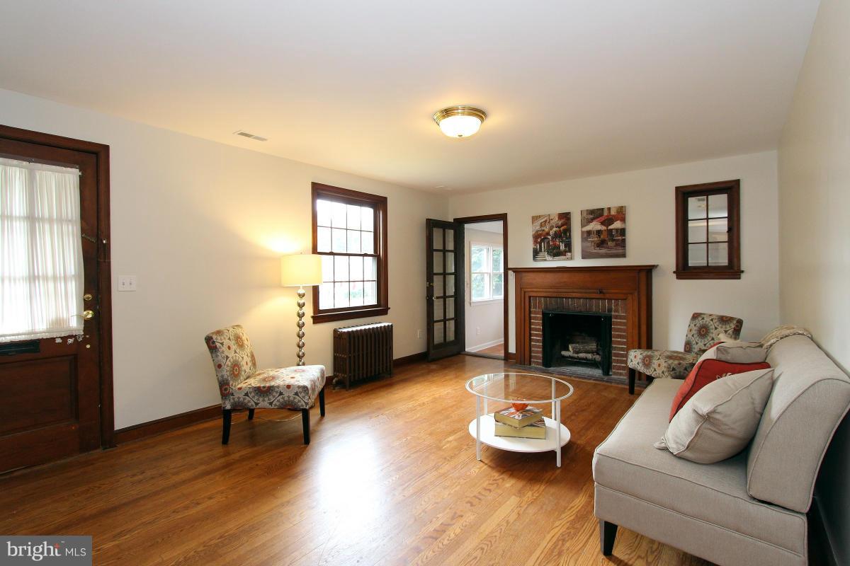 10022 Dallas Avenue Silver Spring, MD 20901 - Photo 5 of 30 a living room with furniture and a fireplace
