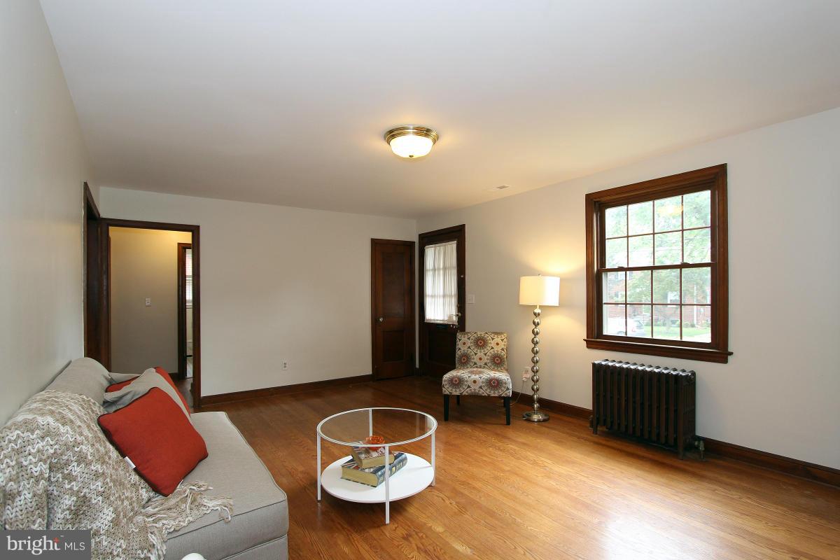10022 Dallas Avenue Silver Spring, MD 20901 - Photo 7 of 30 a living room with furniture and a lamp