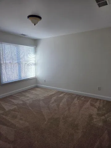 an empty room with a empty space and windows