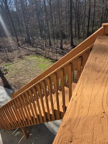 a view of balcony with wooden floor and fence