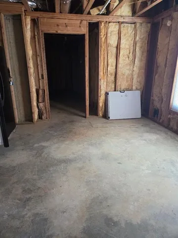 a view of an empty room with a fireplace