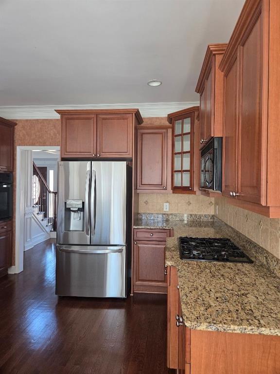 465 Young James Circle Stockbridge, GA 30281 - Photo 7 of 45 a kitchen with granite countertop a refrigerator and wooden cabinets
