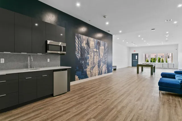a kitchen with stainless steel appliances kitchen island granite countertop a sink and cabinets