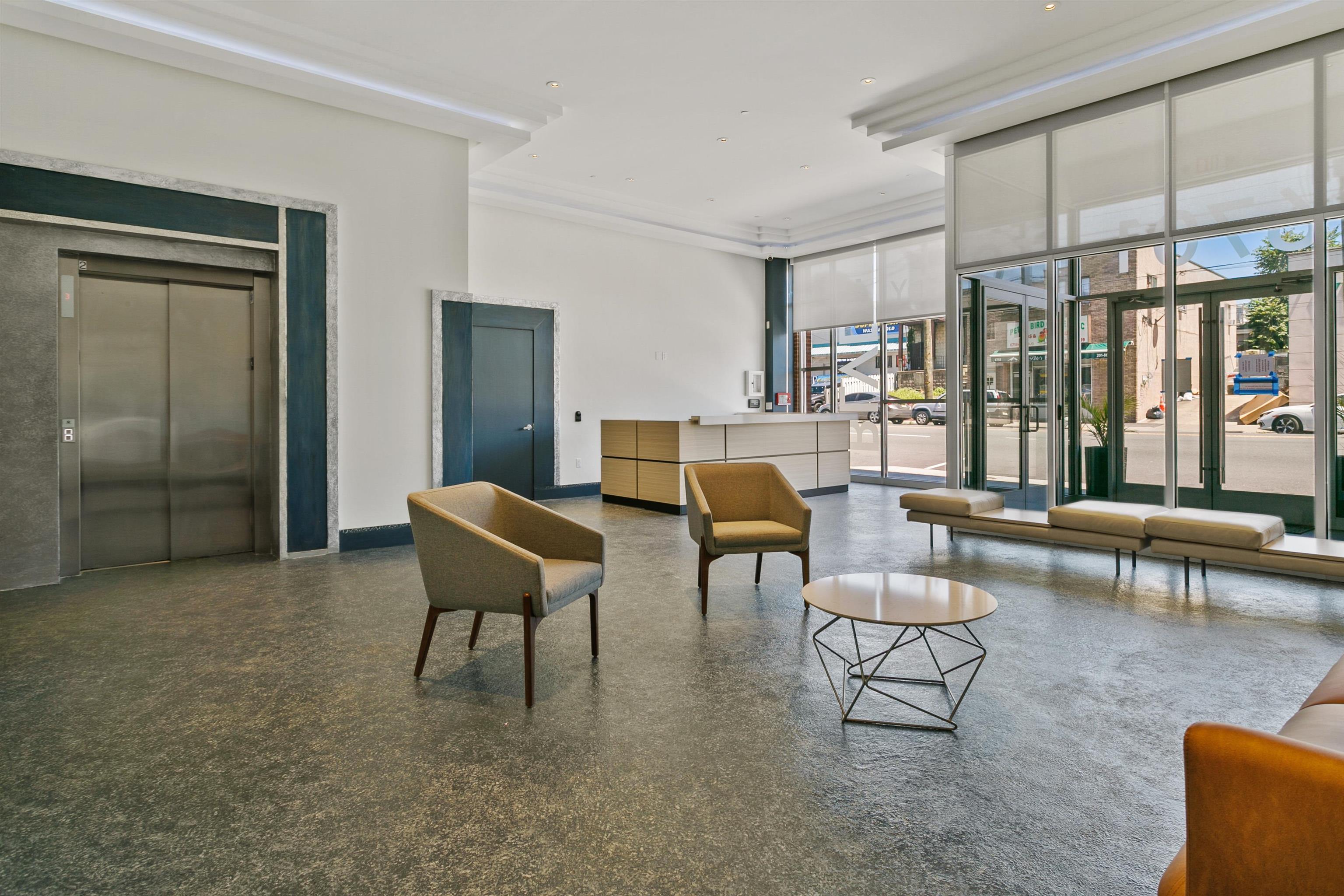 6701 John F. Kennedy Boulevard, Unit 215 North Bergen, NJ 07047 - Photo 12 of 14 a living room with furniture and a large window