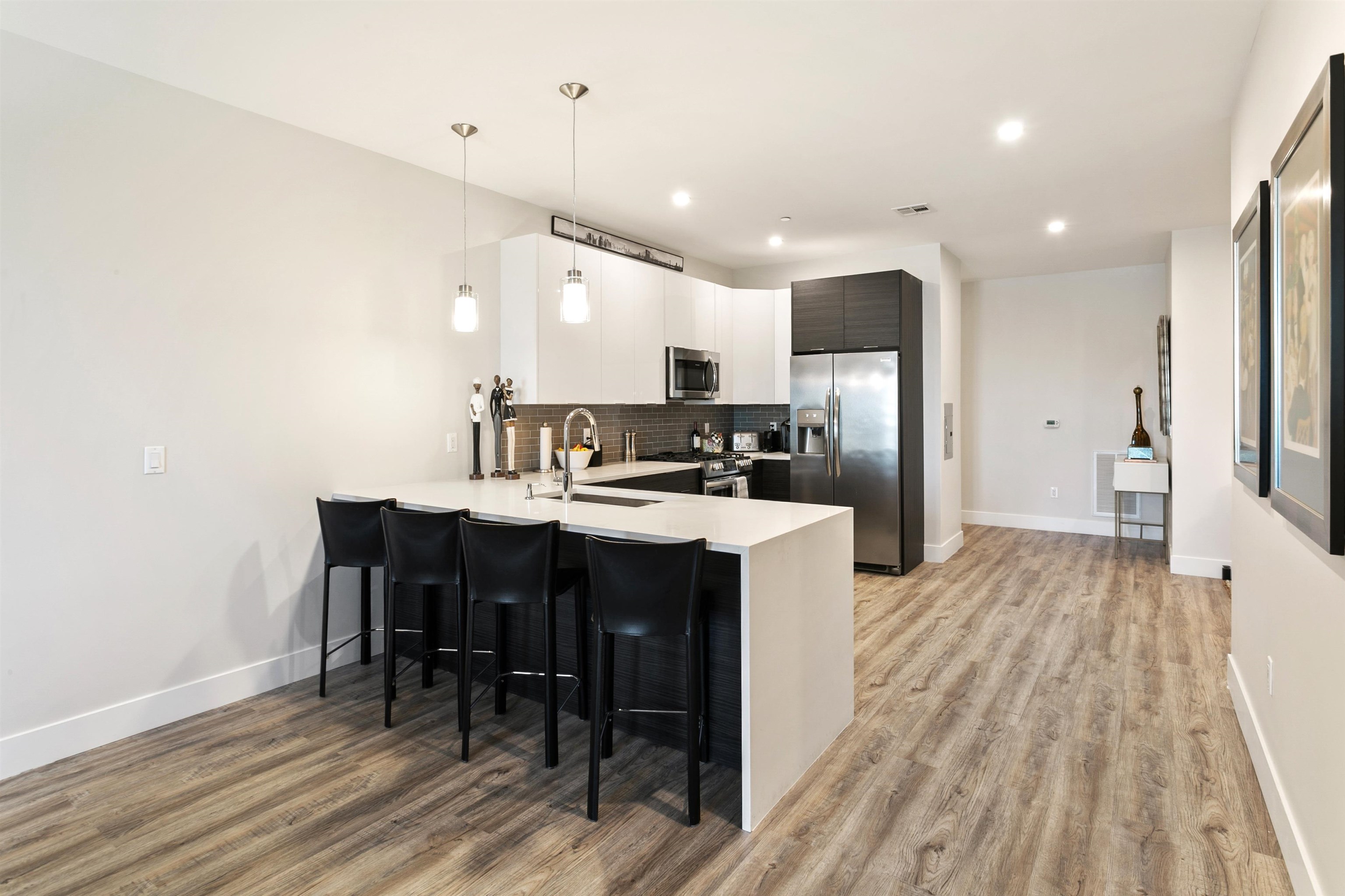 6701 John F. Kennedy Boulevard, Unit 215 North Bergen, NJ 07047 - Photo 5 of 14 a kitchen with kitchen island wooden floors appliances and cabinets