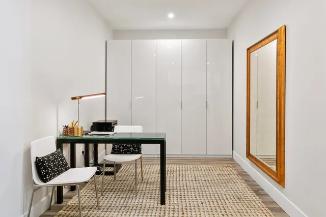 a view of a bedroom with furniture and wooden floor