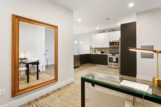 a kitchen with kitchen island a counter top space appliances and a refrigerator