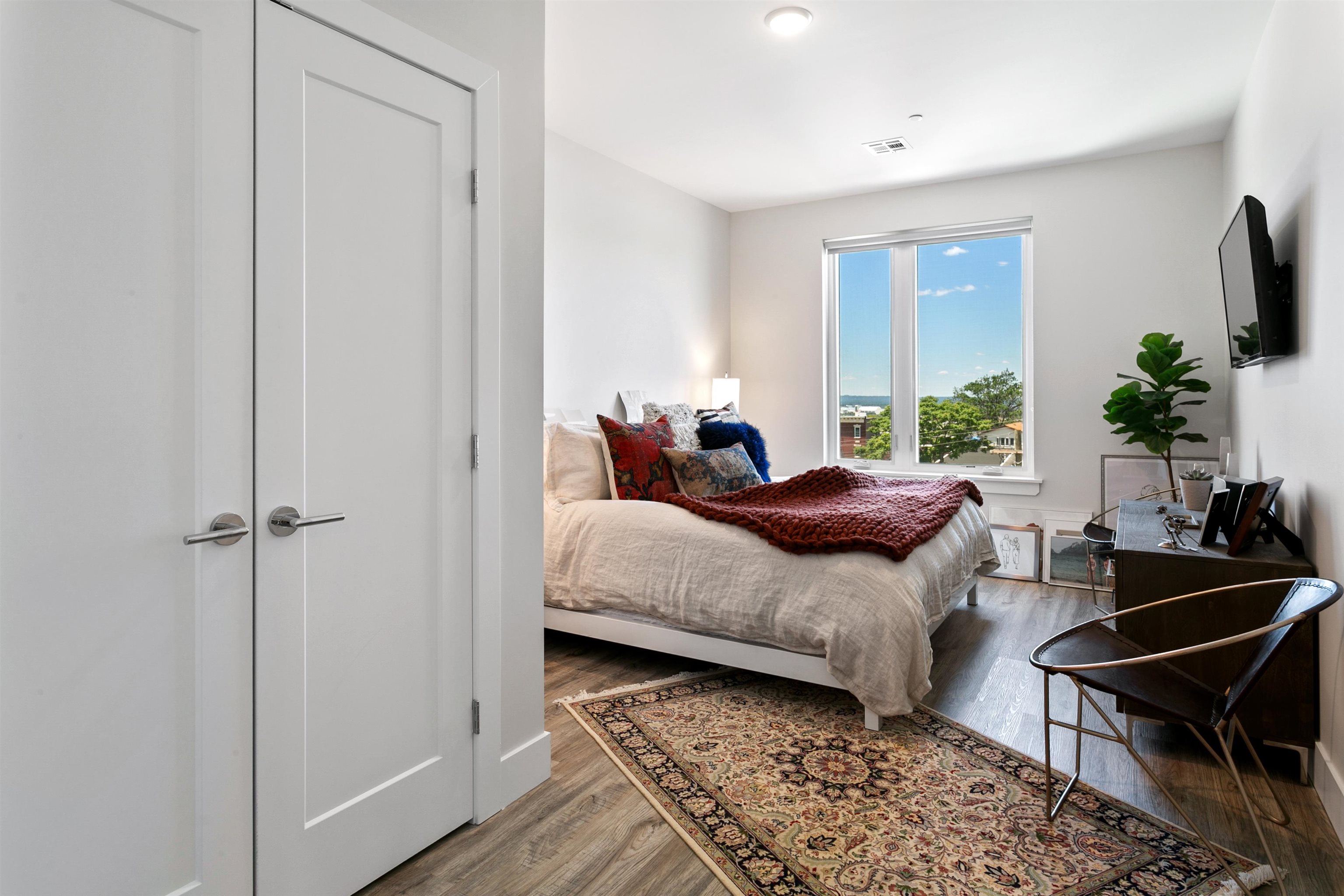 6701 John F. Kennedy Boulevard, Unit 215 North Bergen, NJ 07047 - Photo 8 of 14 a living room with furniture and a flat screen tv