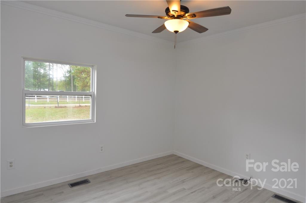 950 Hopps Road, Unit 10 Chester, SC 29706 - Photo 8 of 30 an empty room with windows and ceiling fan