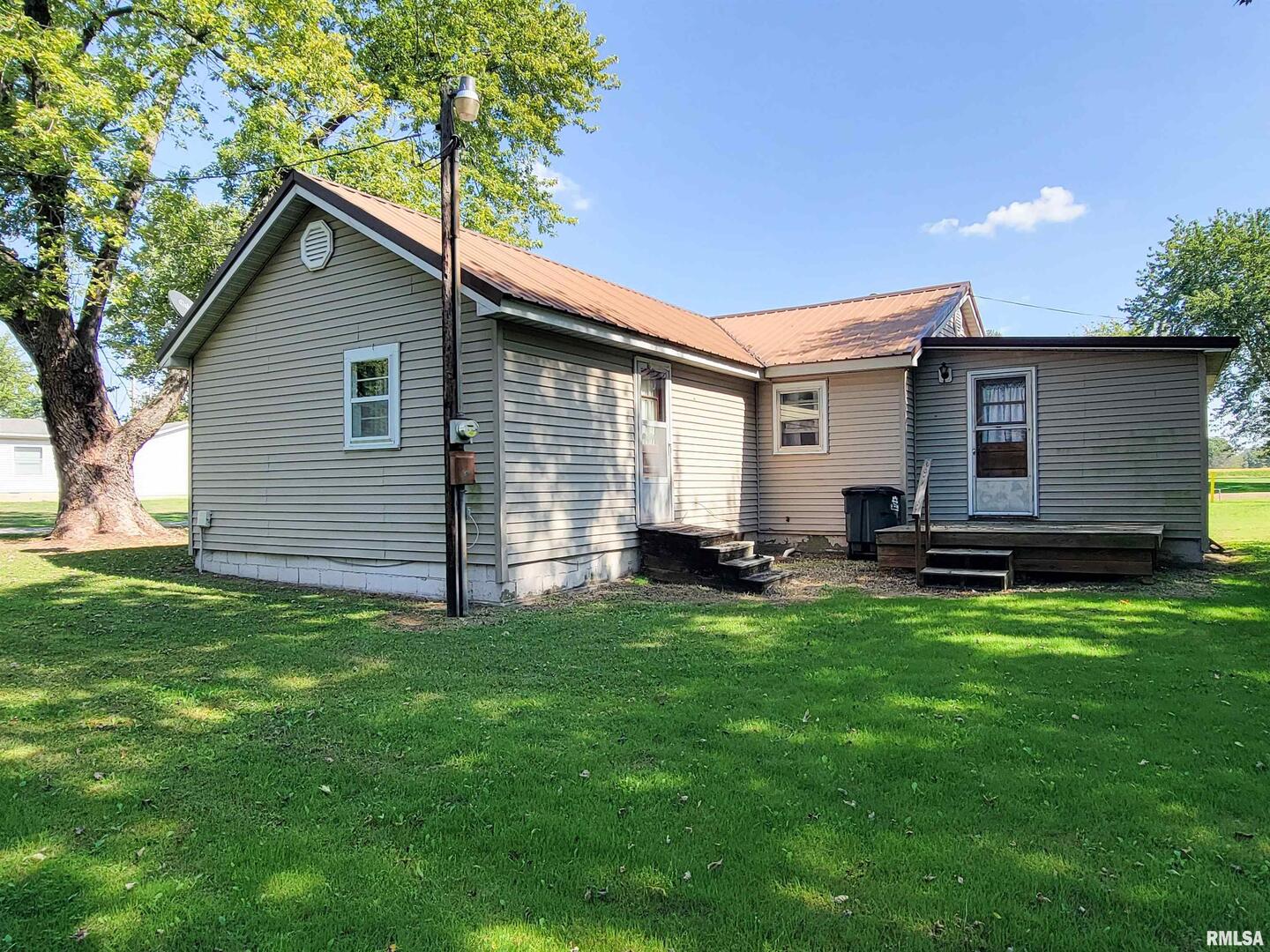 113 Mead Street Southwest Clay City, IL 62824 - Photo 4 of 61 a backyard of a house with table and chairs