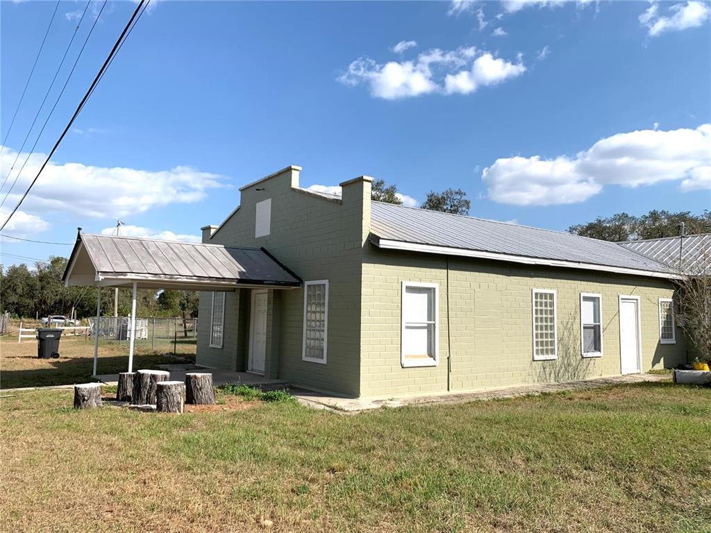 100 John Street Frostproof, FL 33843 - Photo 2 of 15 a view of a house with backyard and porch
