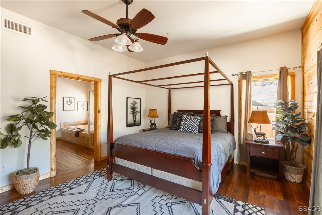 42577 Bear Loop Big Bear City, CA 92314 - Photo 23 of 38 a bedroom with a bed and wooden floor