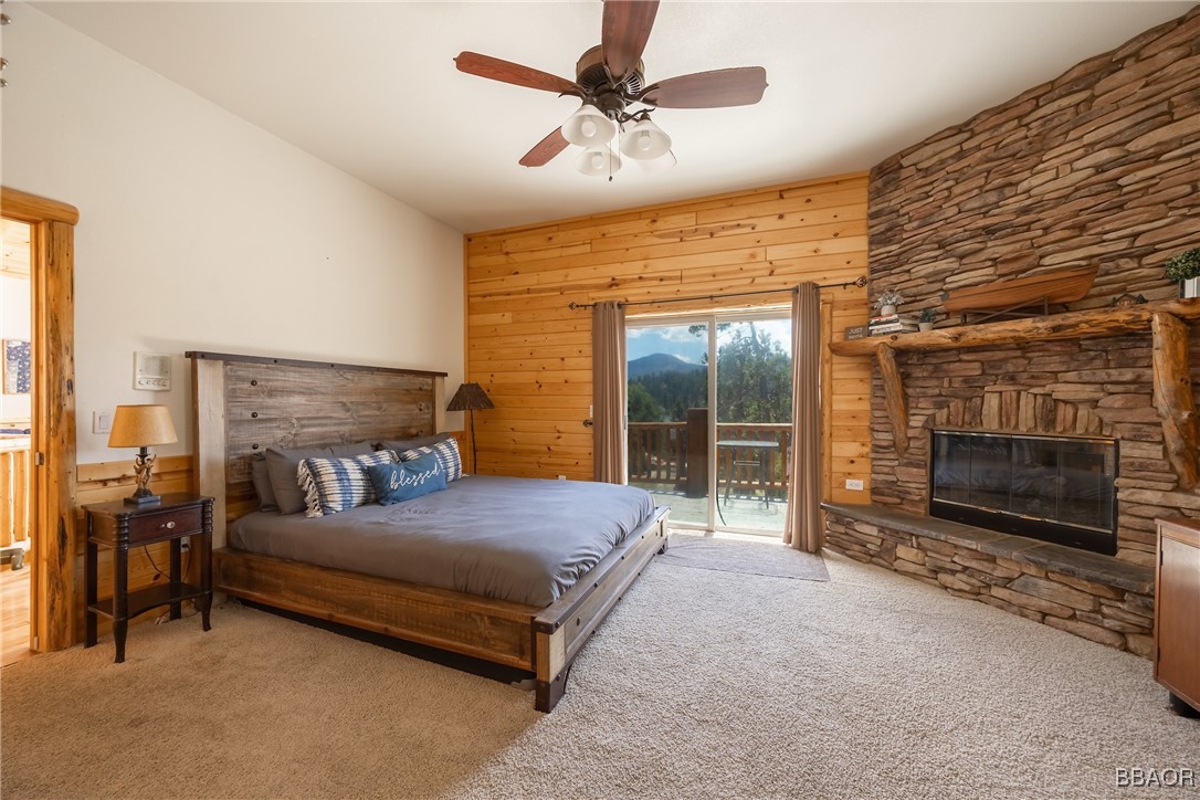 42577 Bear Loop Big Bear City, CA 92314 - Photo 25 of 38 a bedroom with a bed and a fireplace