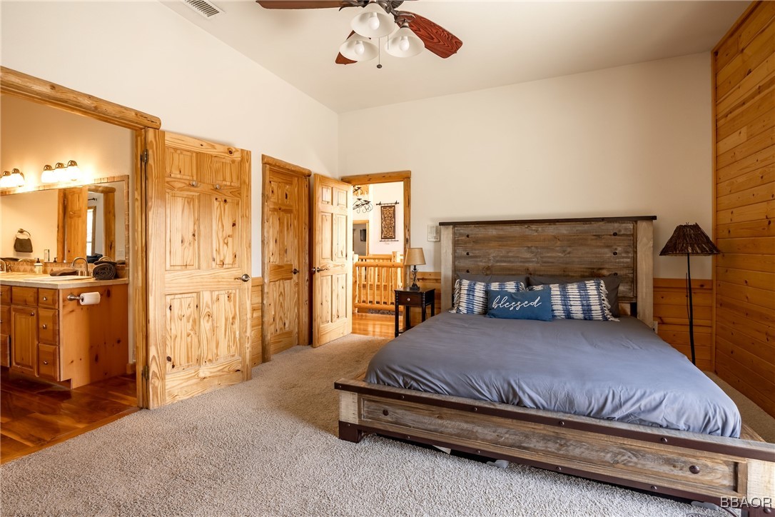 42577 Bear Loop Big Bear City, CA 92314 - Photo 27 of 38 a bedroom with a bed and large cabinets