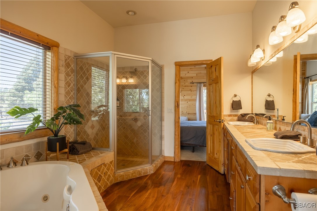 42577 Bear Loop Big Bear City, CA 92314 - Photo 28 of 38 a spacious bathroom with a tub sink and mirror