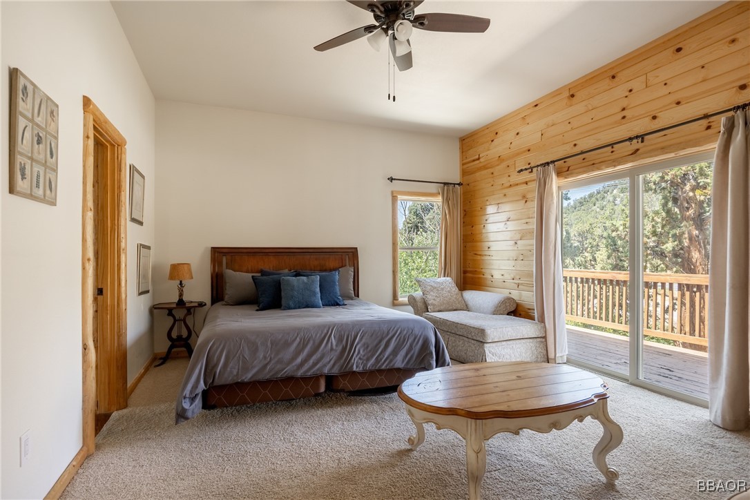 42577 Bear Loop Big Bear City, CA 92314 - Photo 30 of 38 a bedroom with a bed a large window and furniture