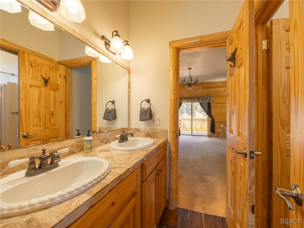 42577 Bear Loop Big Bear City, CA 92314 - Photo 32 of 38 a bathroom with a double vanity sink and a mirror