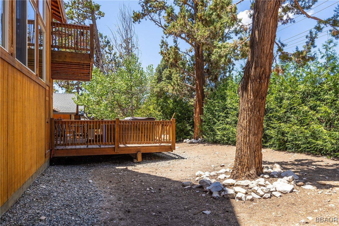 42577 Bear Loop Big Bear City, CA 92314 - Photo 37 of 38 a view of a backyard with large trees and wooden fence