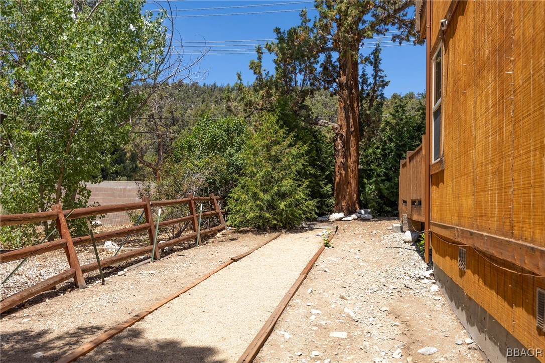 42577 Bear Loop Big Bear City, CA 92314 - Photo 38 of 38 a view of backyard with wooden fence and trees