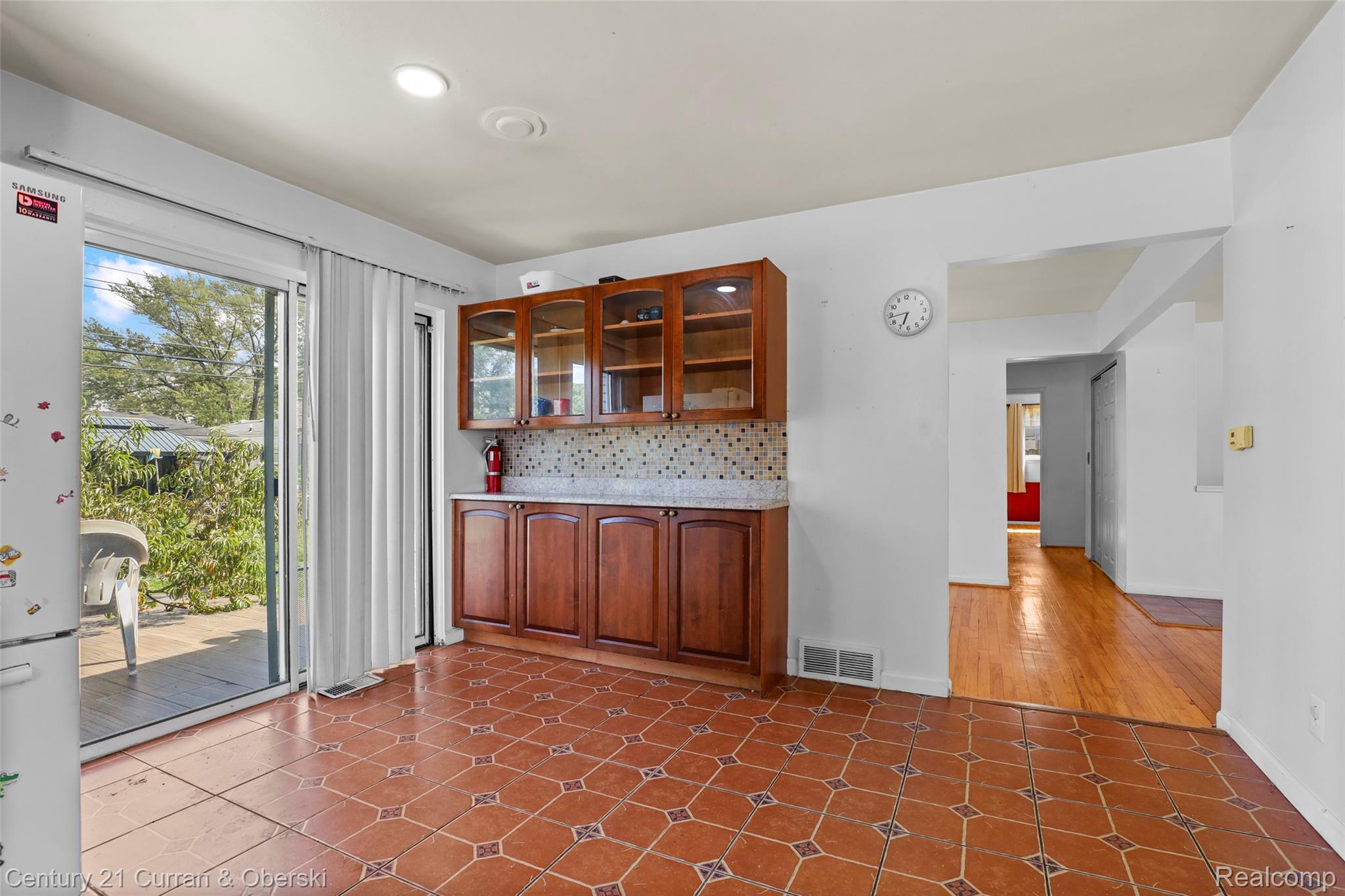 704 Inkster Road Dearborn Heights, MI 48127 - Photo 12 of 32 Patterned tile flooring, built-in cabinetry with glass-front uppers, a sliding glass door, and recessed lighting