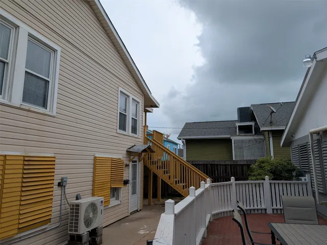a view of house with deck and furniture