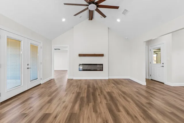 wooden floor in an empty room with a window