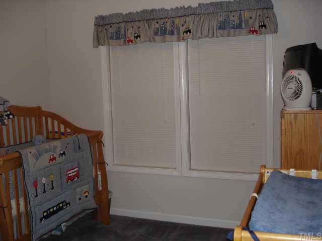 4840 Windbreak Lane Raleigh, NC 27616 - Photo 3 of 6 a view of bedroom with baby crib and dresser