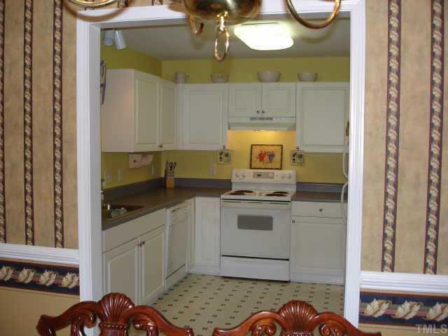 4840 Windbreak Lane Raleigh, NC 27616 - Photo 4 of 6 a kitchen with stainless steel appliances granite countertop a stove a sink and a microwave