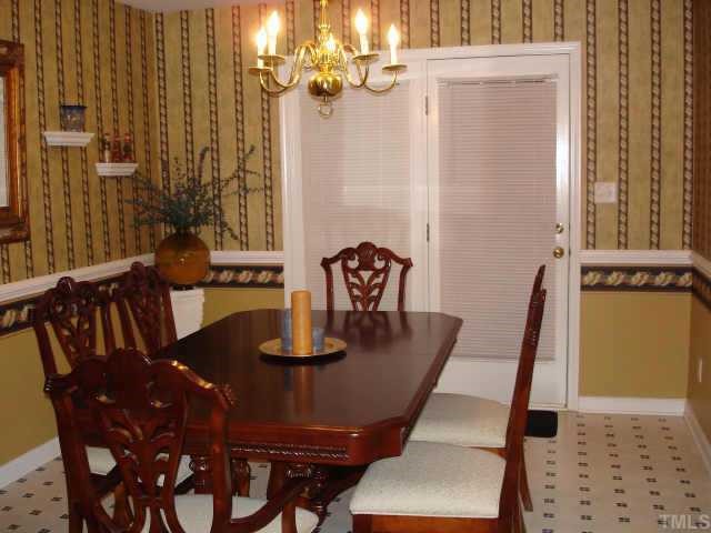 4840 Windbreak Lane Raleigh, NC 27616 - Photo 5 of 6 a view of a dining room with furniture and wooden floor