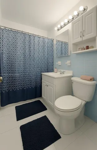 a bathroom with a toilet a sink and mirror