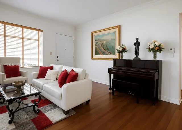 a living room with furniture and wooden floor