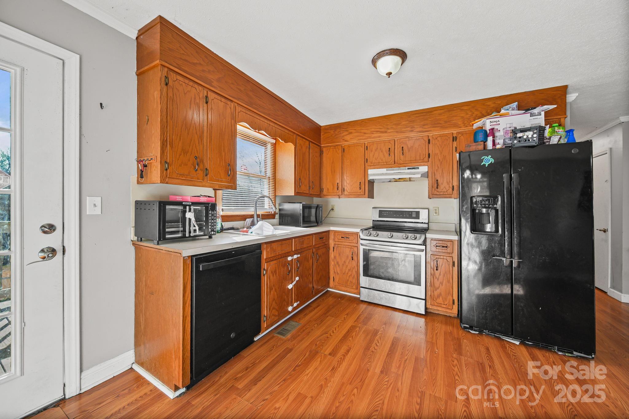 3405 Clarks Chapel Road Lenoir, NC 28645 - Photo 11 of 25 a kitchen with stainless steel appliances a refrigerator and a stove top oven