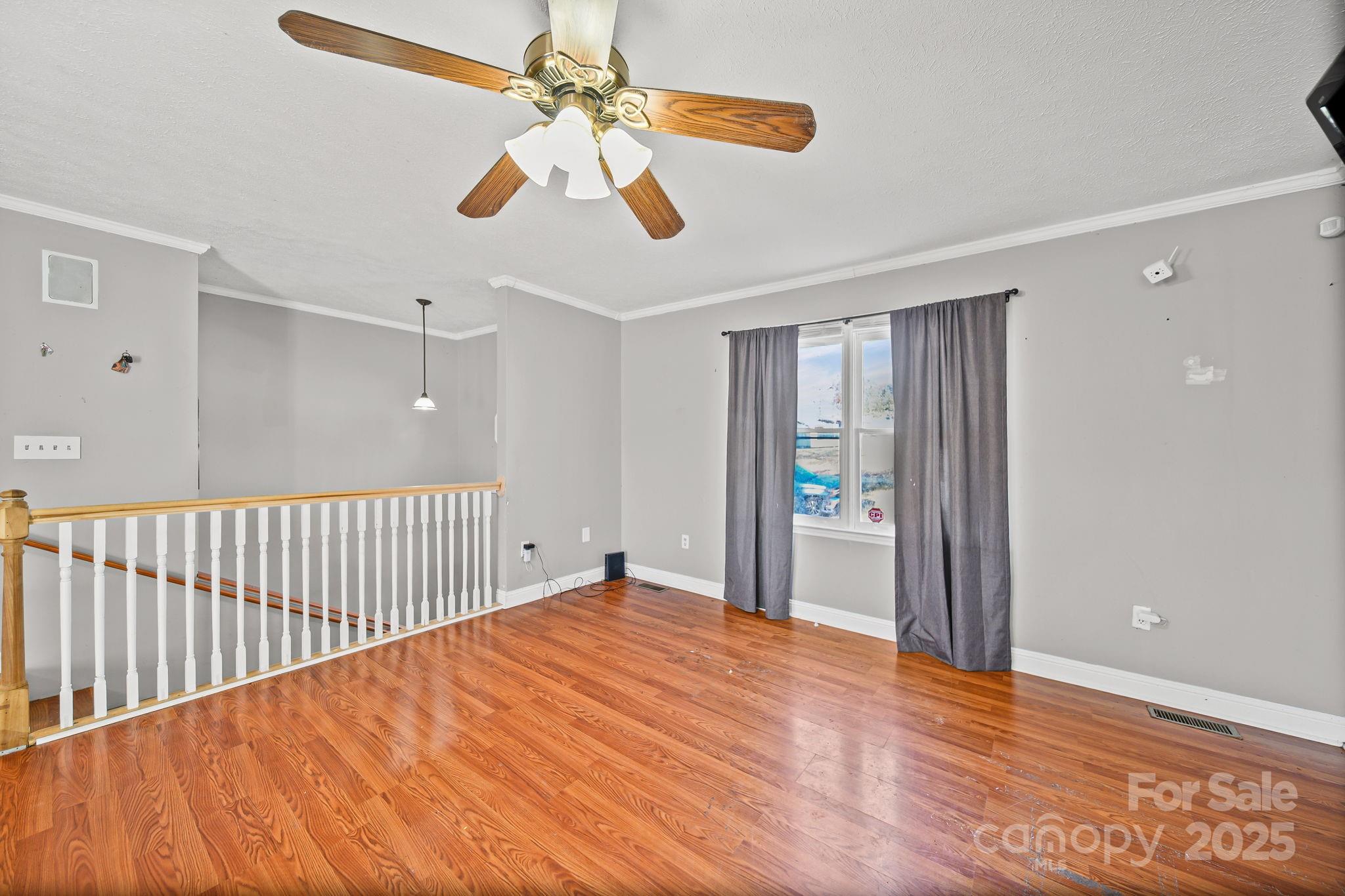 3405 Clarks Chapel Road Lenoir, NC 28645 - Photo 15 of 25 a view of a room with wooden floor and ceiling fan