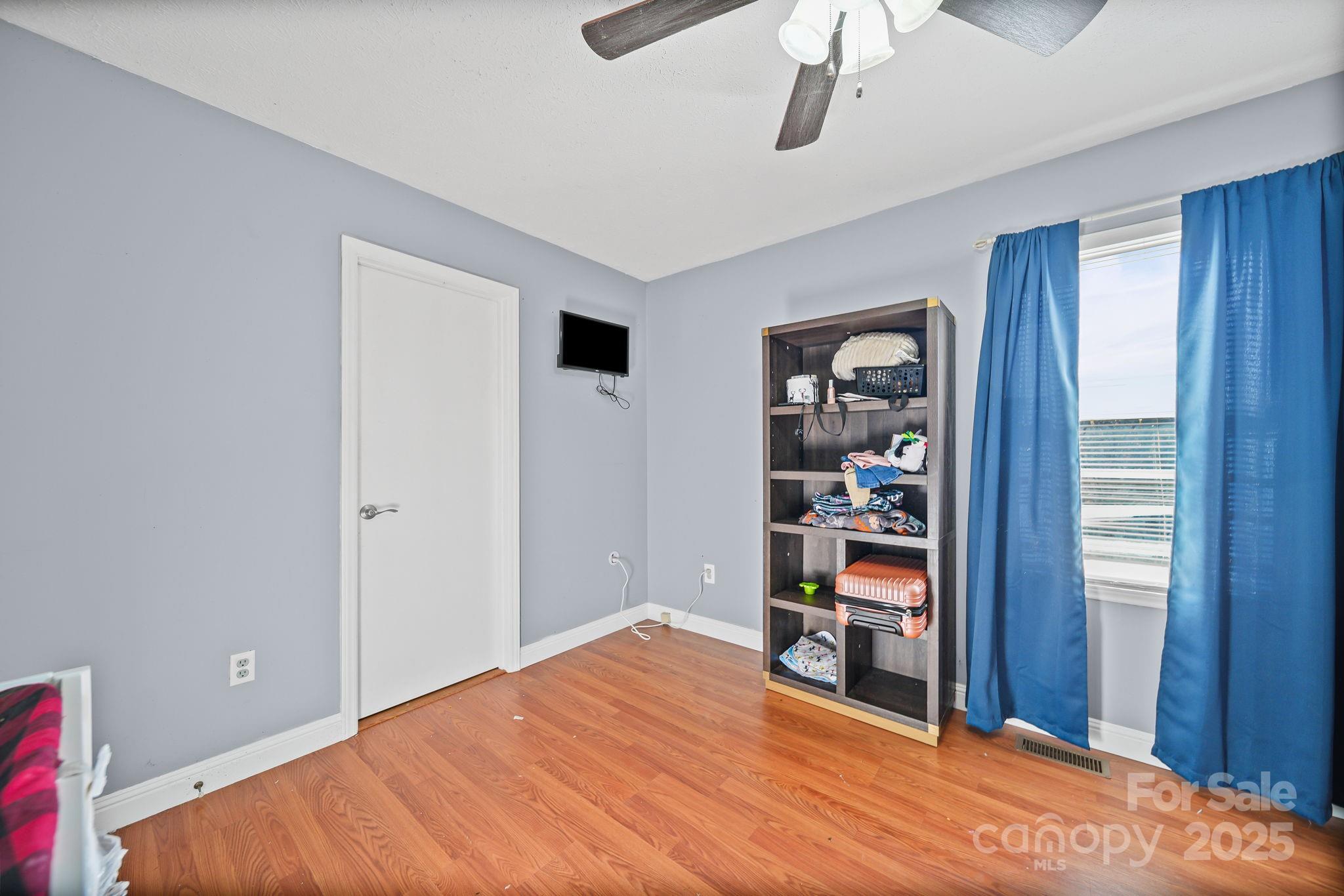 3405 Clarks Chapel Road Lenoir, NC 28645 - Photo 19 of 25 a bed room with a bed and a book shelf