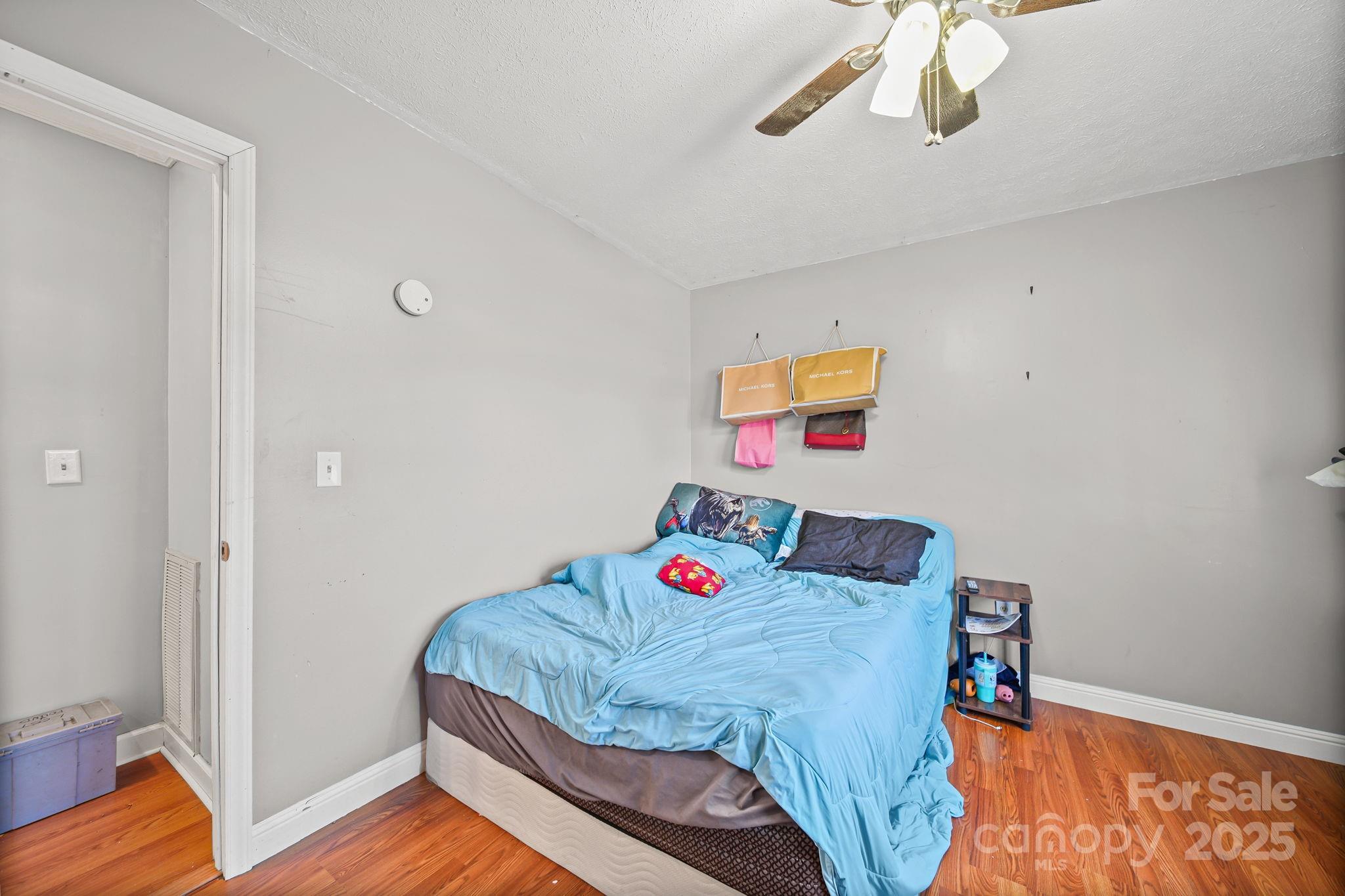 3405 Clarks Chapel Road Lenoir, NC 28645 - Photo 21 of 25 a bedroom with a bed and wooden floor
