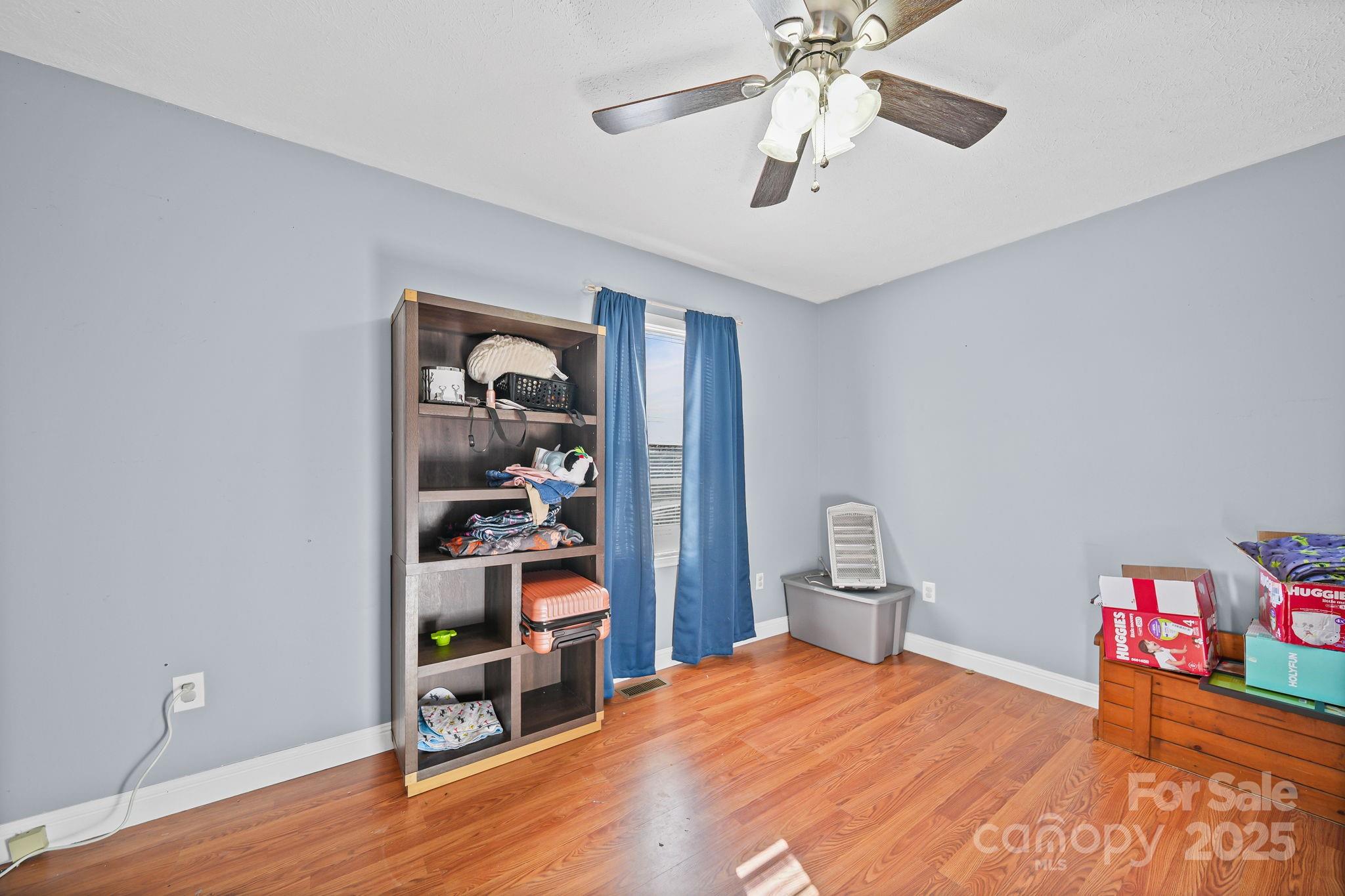 3405 Clarks Chapel Road Lenoir, NC 28645 - Photo 22 of 25 a bedroom with a bed and a chandelier