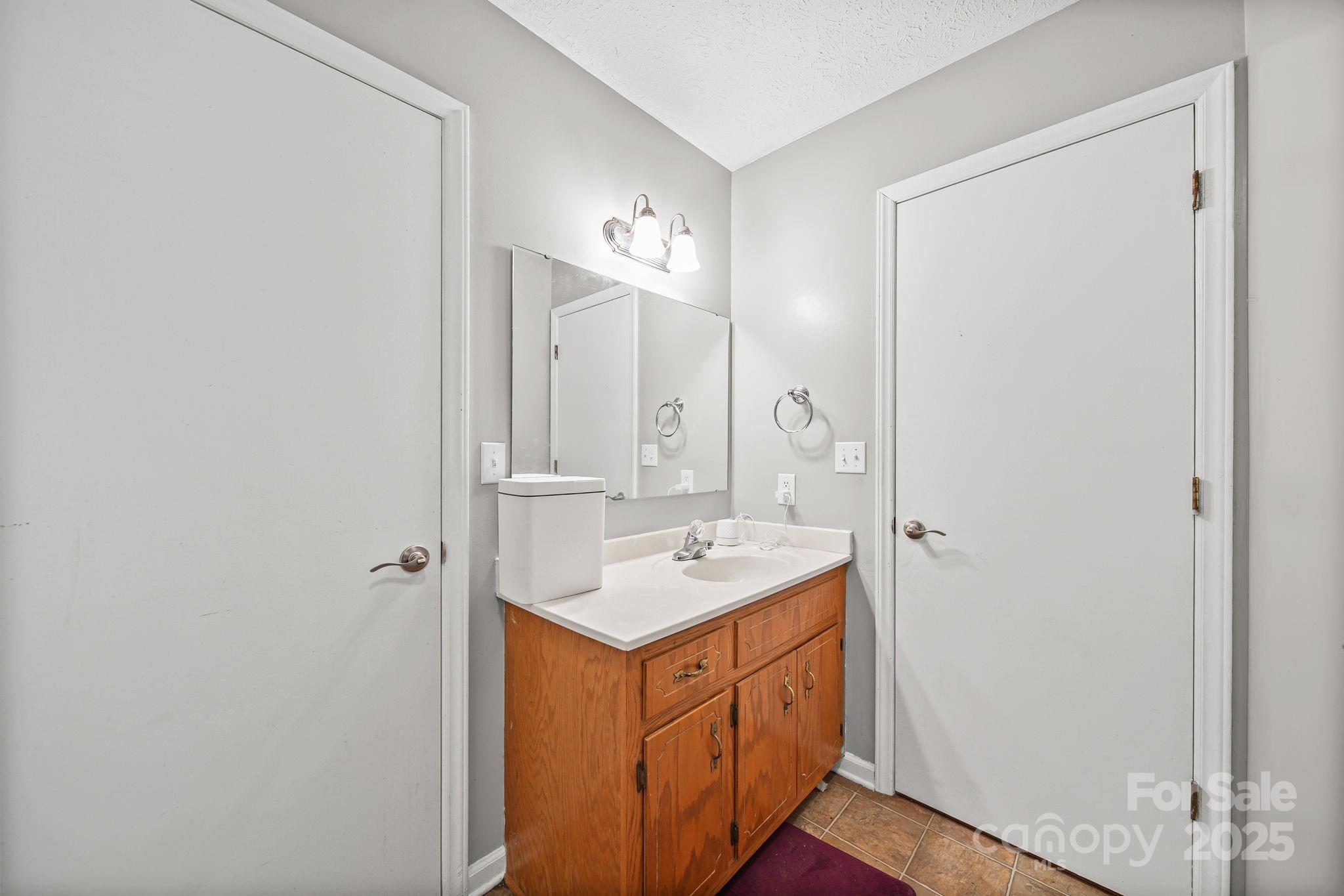 3405 Clarks Chapel Road Lenoir, NC 28645 - Photo 24 of 25 a bathroom with a sink a mirror and a shower