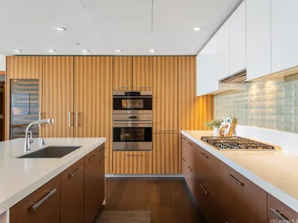 a kitchen with stainless steel appliances granite countertop a sink stove and cabinets