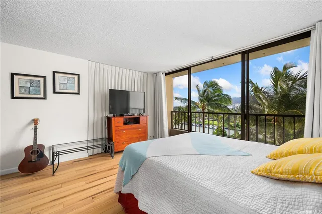 a bedroom with a bed and a large window