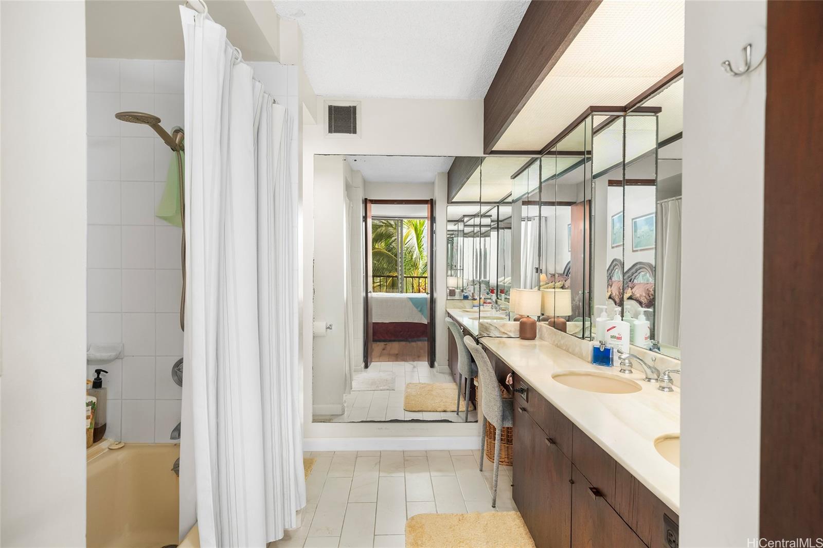 500 Lunalilo Home Road, Unit 26L Honolulu, HI 96825 - Photo 10 of 24 a large bathroom with a double vanity sink a mirror and a shower