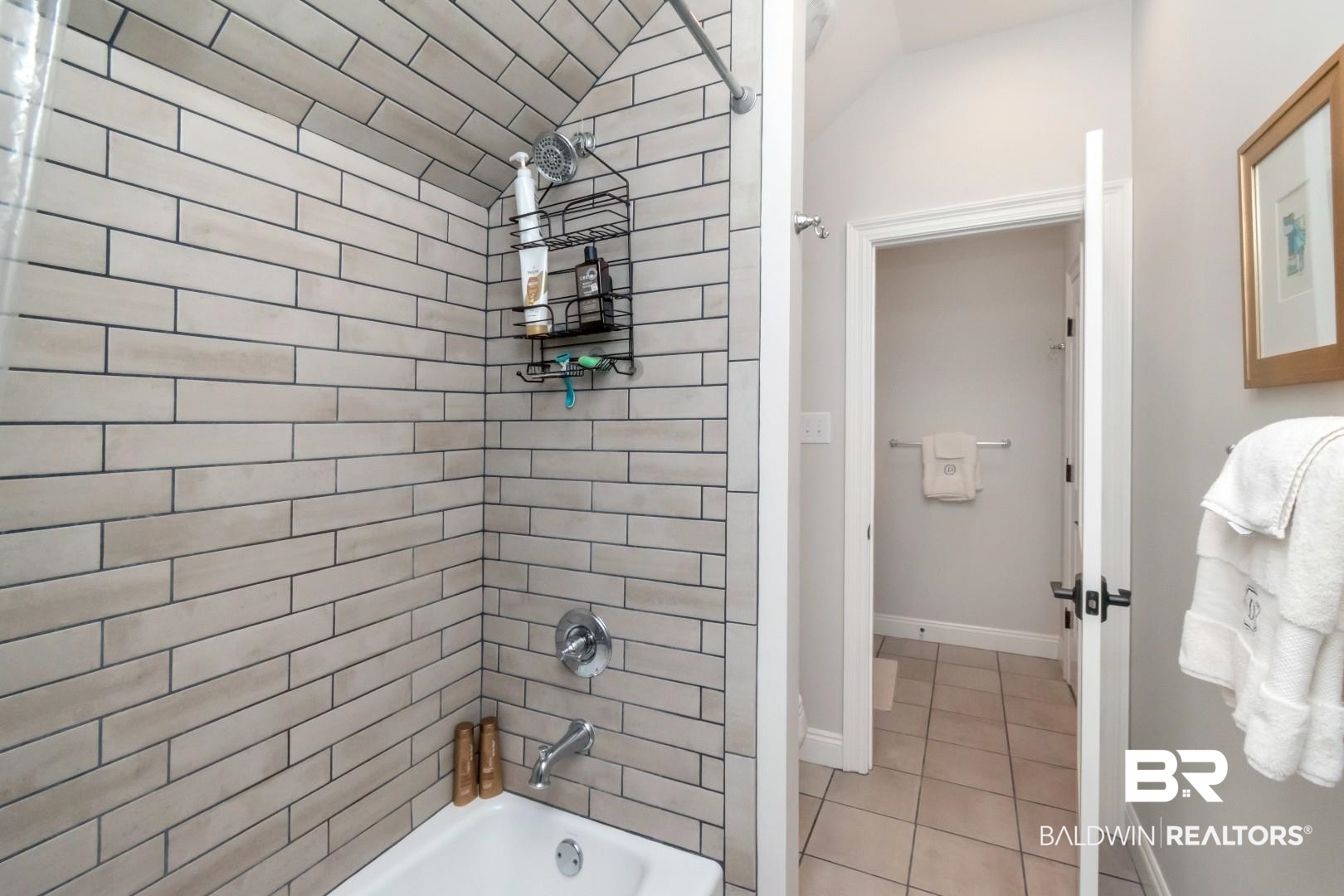 4404 Stein Street Mobile, AL 36608 - Photo 38 of 50 Bathroom with shower / washtub combination, light tile patterned floors, and vaulted ceiling