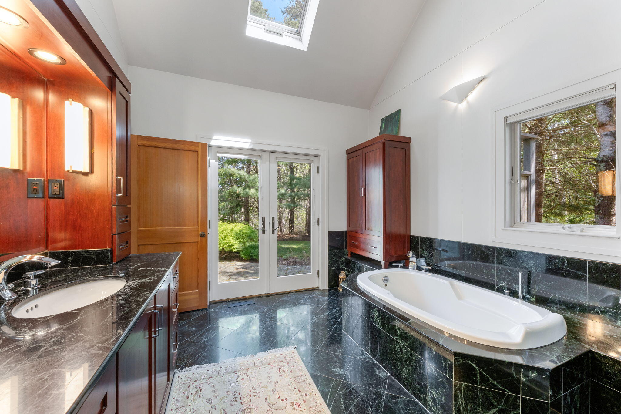 476 Baxter Neck Road Marstons Mills, MA 02648 - Photo 37 of 95 a bathroom with a granite countertop sink a toilet a mirror and a window