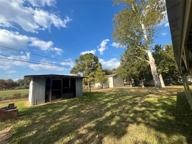 a view of house with backyard