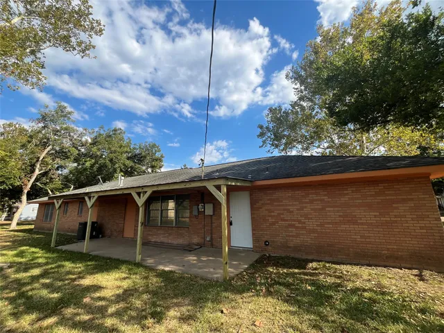 a view of a tree in the backyard of a house