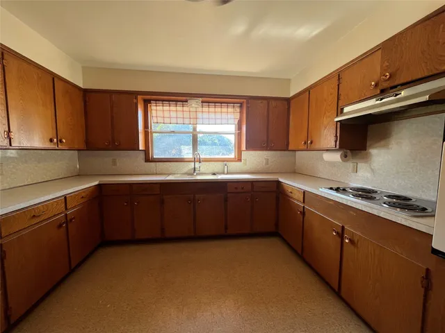 a kitchen with a sink a stove a microwave and cabinets