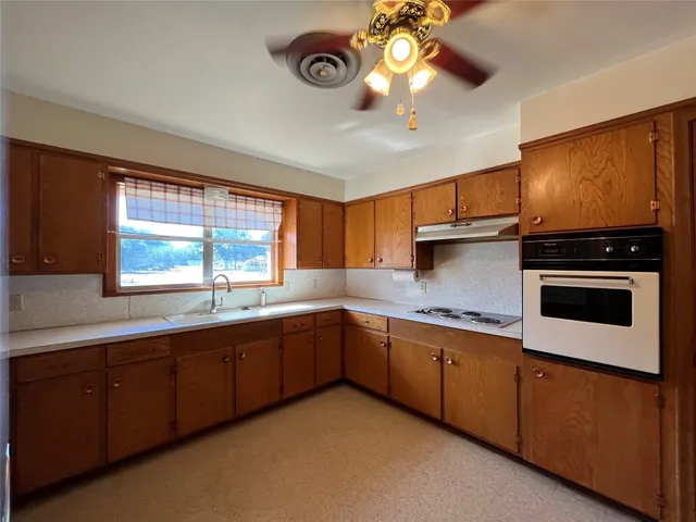 a kitchen with stainless steel appliances a stove sink and cabinets