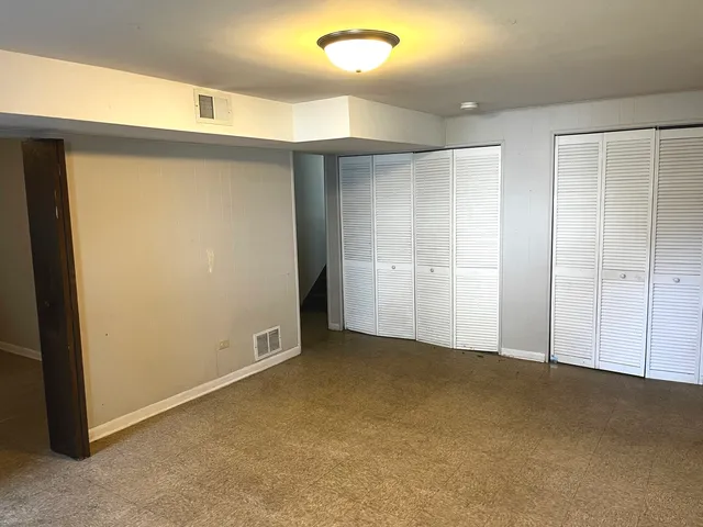 an empty room with closet area
